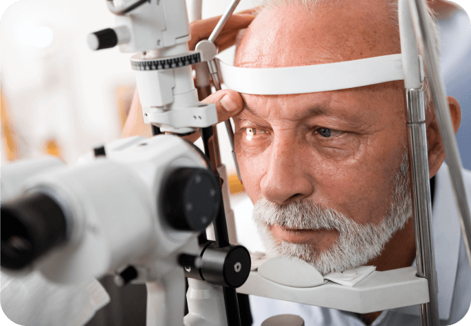 A senior man is engaged in an eye examination with an eye examining instrument